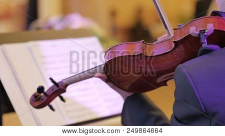 Male Performs Lead Violin Sole Part Playing At Classical Concert. Professional Symphonic Orchestra M