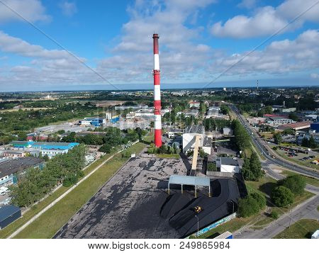 Heating Plant With High Chimney In City Area, Aerial View.