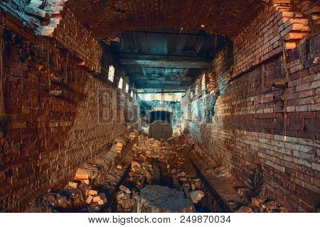 Light And Exit In End Of Dark Long Brick Abandoned Industrial Tunnel Or Corridor Or Sewer Channel, W