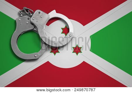 Burundi Flag  And Police Handcuffs. The Concept Of Crime And Offenses In The Country.