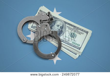 Micronesia Flag  With Handcuffs And A Bundle Of Dollars. Currency Corruption In The Country. Financi