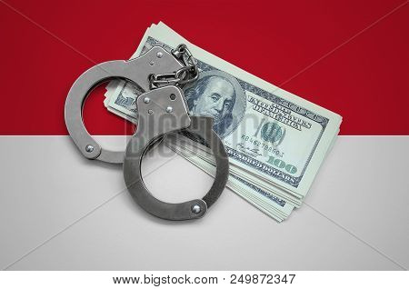 Indonesia Flag  With Handcuffs And A Bundle Of Dollars. Currency Corruption In The Country. Financia