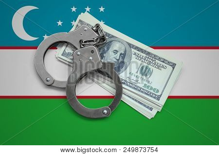 Uzbekistan Flag  With Handcuffs And A Bundle Of Dollars. Currency Corruption In The Country. Financi