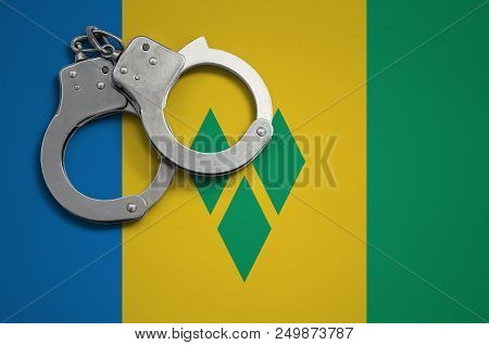 Saint Vincent And The Grenadines Flag  And Police Handcuffs. The Concept Of Crime And Offenses In Th