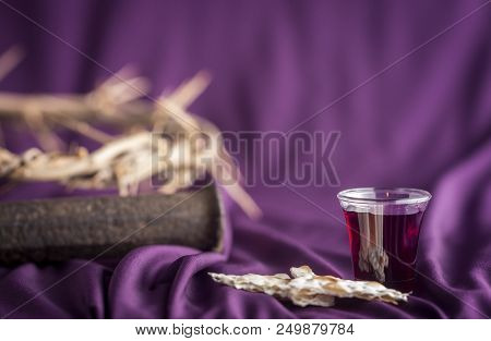 Commuion And Symbols Of The Crusifixion On A Purple Cloth