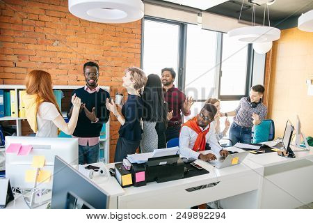 Sad African Guy Cannot Work On Laptop Because Of Noisy Colleagues In The Small Office. Draw Worker A