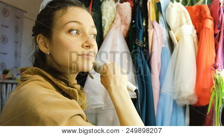 Young Beautiful Girl Curls Her Hair On A Curling Robe In The Dressing Room.