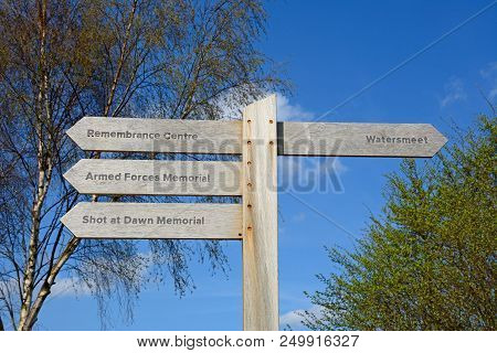 Alrewas, Uk - April 18, 2018 - Wooden Memorials Fingerpost Sign At The National Memorial Arboretum, 