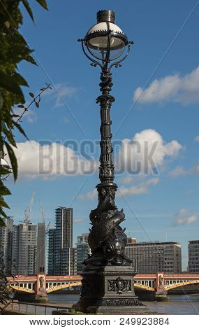 Lamp Post With Fish Design On Riverside Promenade Of The River Thames At Millbank, London, England