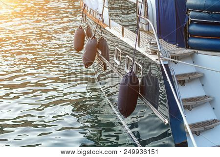 Close Up Of Sailboat Side Fenders . A Fender (boating) Hanging On The Board To Protect The Side Of T