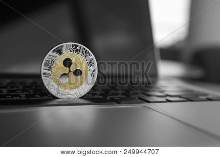 Silver Gold Ripple Coin On A Laptop Keyboard Closeup. Blockchain Mining. Digital Money And Virtual C