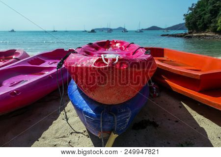 Red And Blue Boats Among The Other Kayak On The The Seacost In Thailand. Parking For Kayaking. Summe