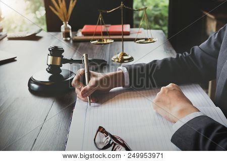 Advice And Justice Concept. Justice Scales And Justice Hammer And Female Lawyer Use Pen, Working Leg