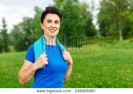 Elderly Female Doing Fitness Exercises Outdoor. Heathy Life Style Concept. Copyspace.