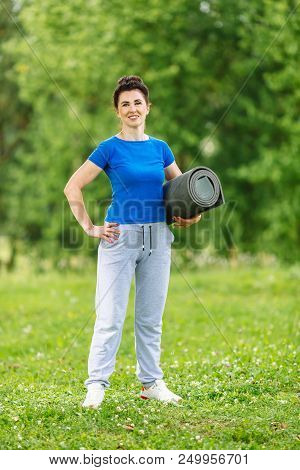 Elderly Female Doing Fitness Exercises Outdoor. Heathy Life Style Concept. Copyspace.