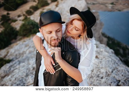 Romantic Summer Love Story On A Sunset In Mountains. Young Girl And Boy In Love.