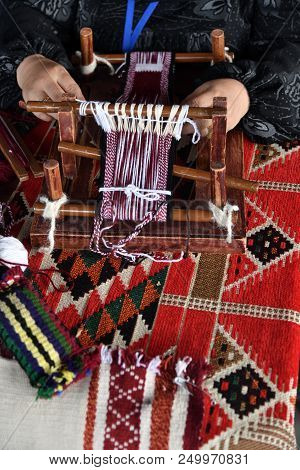 A Senior Arabian Woman Makes A Traditional Sadu Weaving. Hands Of A Weaver Close-up, Focus On The Fr
