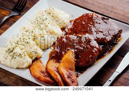 Asado Negro With Mashed Potatoes And Fried Plantain
