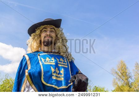 Ancient Swedish Soldier With Three Crowns  On The Blue Uniform, Performing During A Battle In Denmar