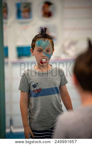 View Of Boy With Face Painted Like A Shark