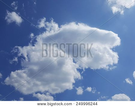 Cummulus Clouds In The Blue Sky On A Sunny Day