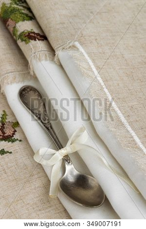 Vintage Russian Silverspoon With Silk Ribbon On Linen Napkin. Old Fashion Heroloom Silverware