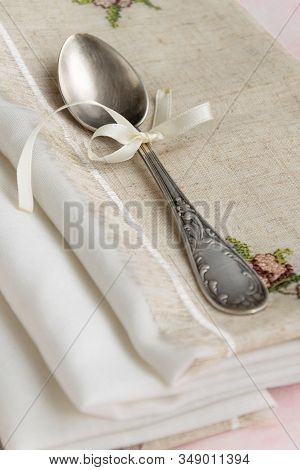Vintage Russian Silverspoon With Silk Ribbon On Linen Napkin. Old Fashion Heroloom Silverware