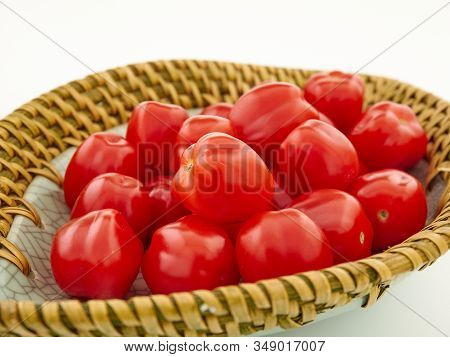 Ripe, red cherry tomatoes of the confetto variety.Isolate.White background