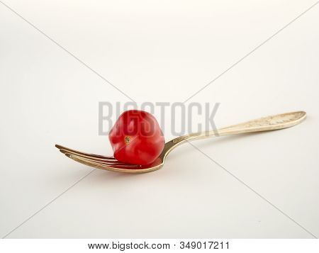 Ripe, red cherry tomatoes of the confetto variety.Isolate.White background