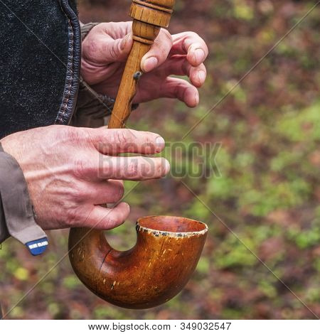 A Close-up Of The Hands Of A Piper Playing The Bagpipe On The Nature Background.