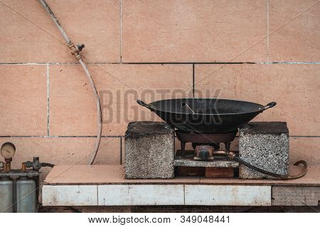 Old Black Metal Pan Wok On A Gas Cooker On A Street Food Stall In China