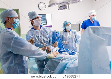 Arthroscope Surgery. Orthopedic Surgeons In Teamwork In The Operating Room
