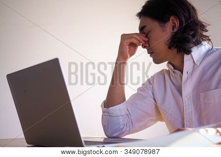 Asian Businessmen Are Tired And Have Eye Strain After Sitting For A Long Time.