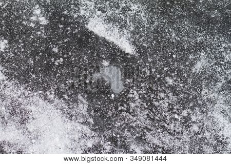 Texutured Ise Surface Of Frozen Lake. Close Up. Scattered White Snow Around. Winter Background.