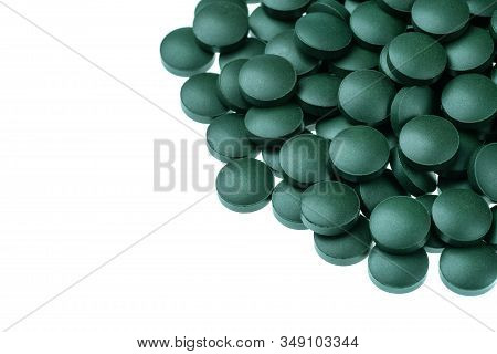 Vitamin And Mineral Supplements For Vegetarians Spirulina In Tablets On A White Background, Close-up