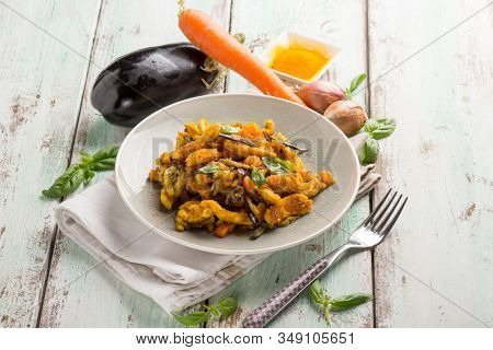 chicken stewed with eggpalnts carrots basil and turmeric spice