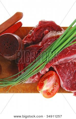 meat portion: bloody beef fillet on plate with cutlery served before cooking