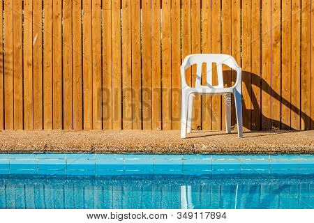Pool Side Relaxation Space Back Yard Blue Water And Wooden Deck Wall Background With White Chair Sim