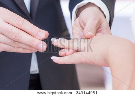 Wedding Bride And Groom Couple At Marriage Ring Vows Ceremony. Husband With Dark Suit And Wife With 