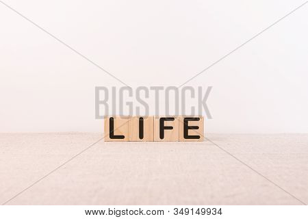 The Word Life Is Written On Wooden Cubes.