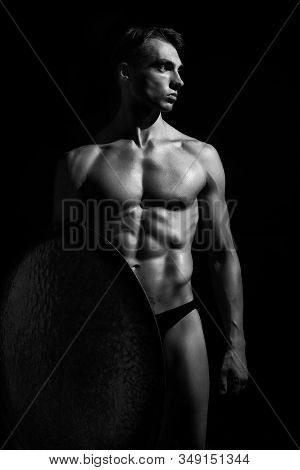 Front View Of Strong Warrior With Perfect Muscular Body. Isolated Black And White Portrait Of Athlet