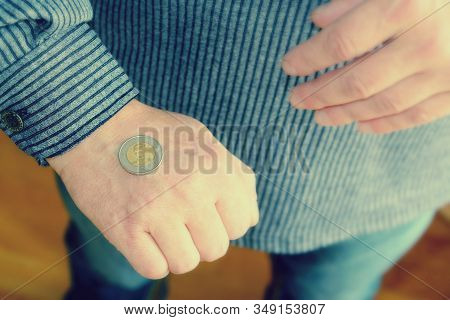 The Spanish Coin Lies On A Male Hand. The Game 
