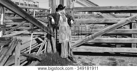 Cowgirl And A Fancy Dress Waiting For Her Cowboy In Black And White.