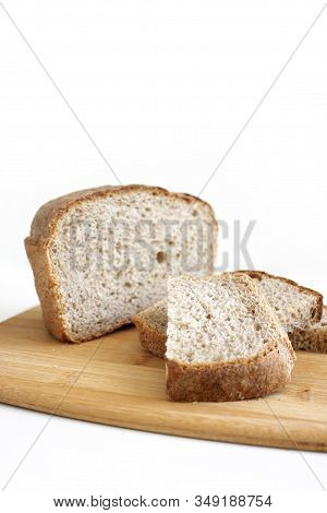 Rye And Wheat Bread. A Piece Of Bread. A Loaf Of Bread On A Cutting Board. Isolated Image. Photo For