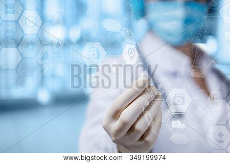 The Concept Of Treatment With Pills. Doctor Shows Pill On Blurred Background.