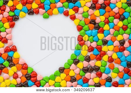 Valentine's Card - Heart-like Small Multi-colored Candies Form A Colored Background Leaving A Space 