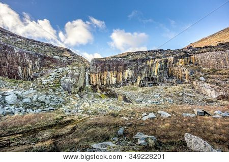 Old Stone Quarry With Waterfall In Mourne Mountains Near Slieve Donard Mountain. This Mountain Range