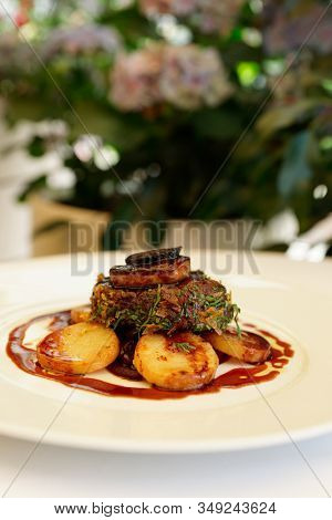 Fillet mignon steak with foie gras and truffle served outdoors