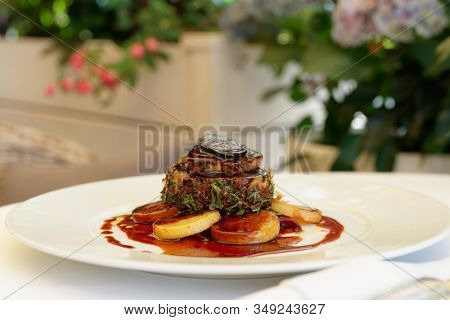 Chateaubriand steak with foie gras and truffle, French dish served on summer patio