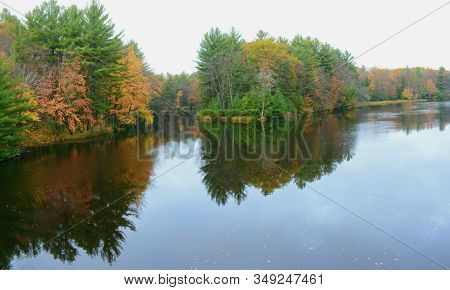 Scenic Autumn Foliage Reflections On The Tranquil Chippewa River, In Brunet Island State Park, Centr